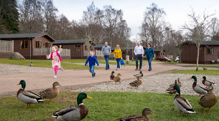 six family members walking together on a caravan holiday park