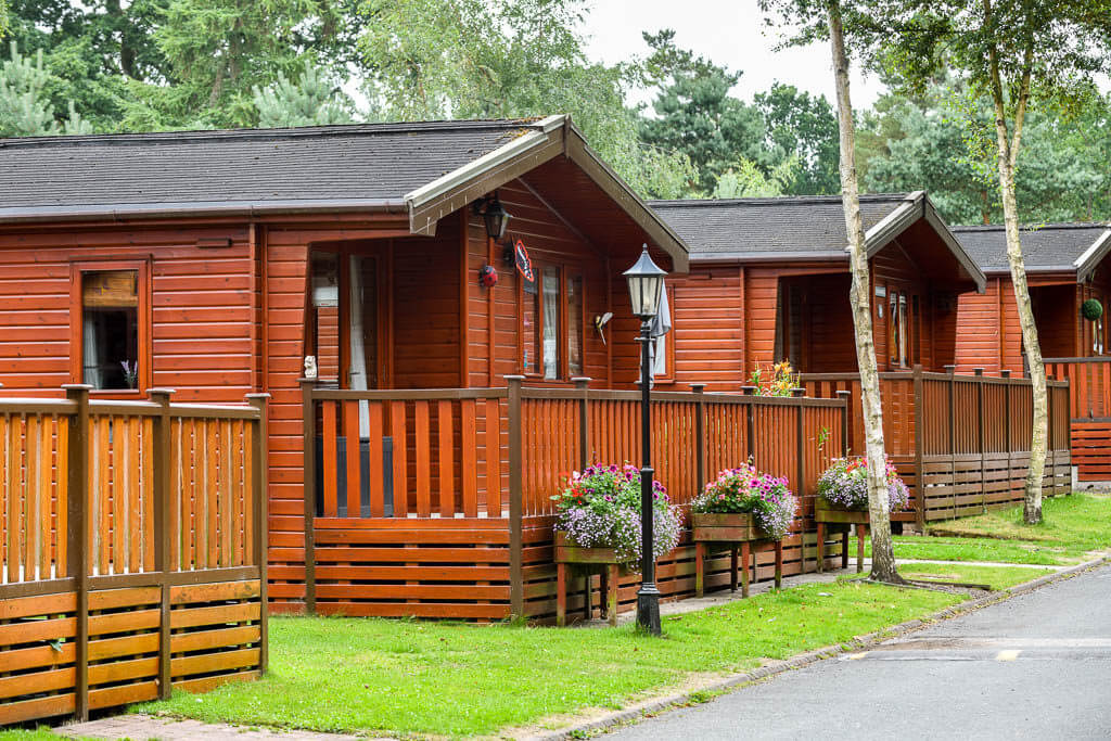 image of brown wooden holiday lodges at a caravan holiday park