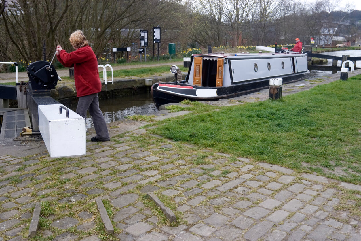 woman operating a narrowboat lock