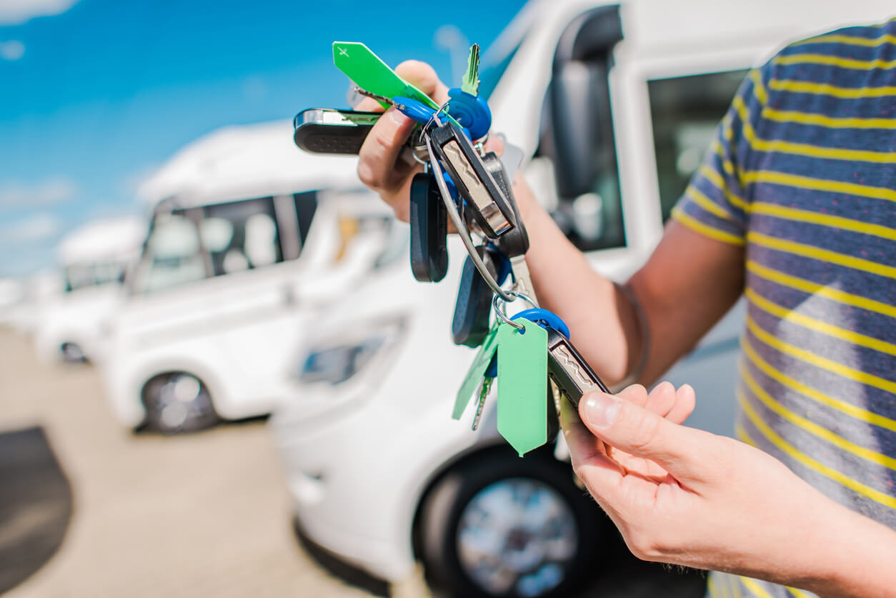 Man holding lots of keys outside of a motorhome