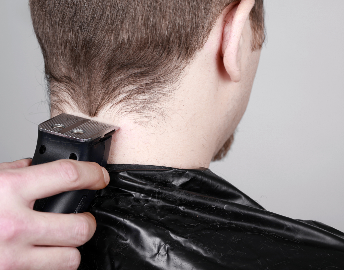 Man having hair cut with hair clippers