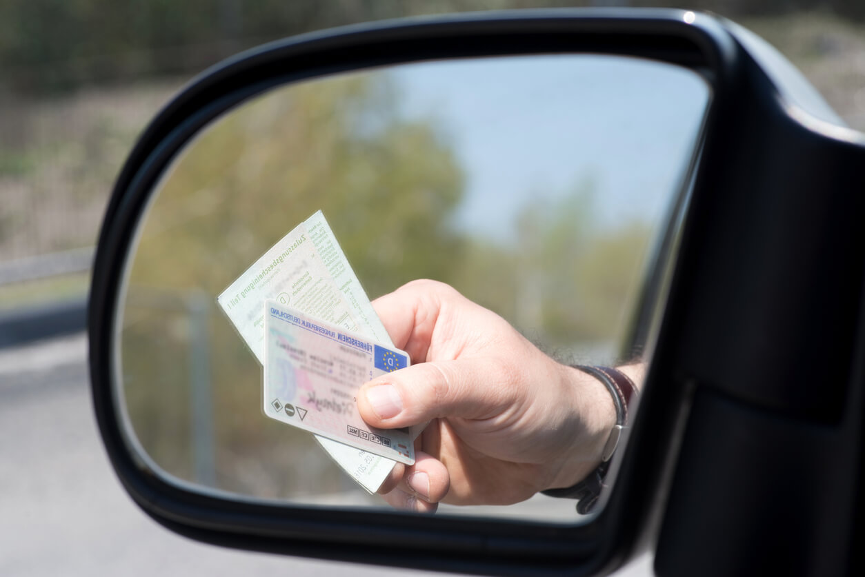 driving-license-outside-car-window